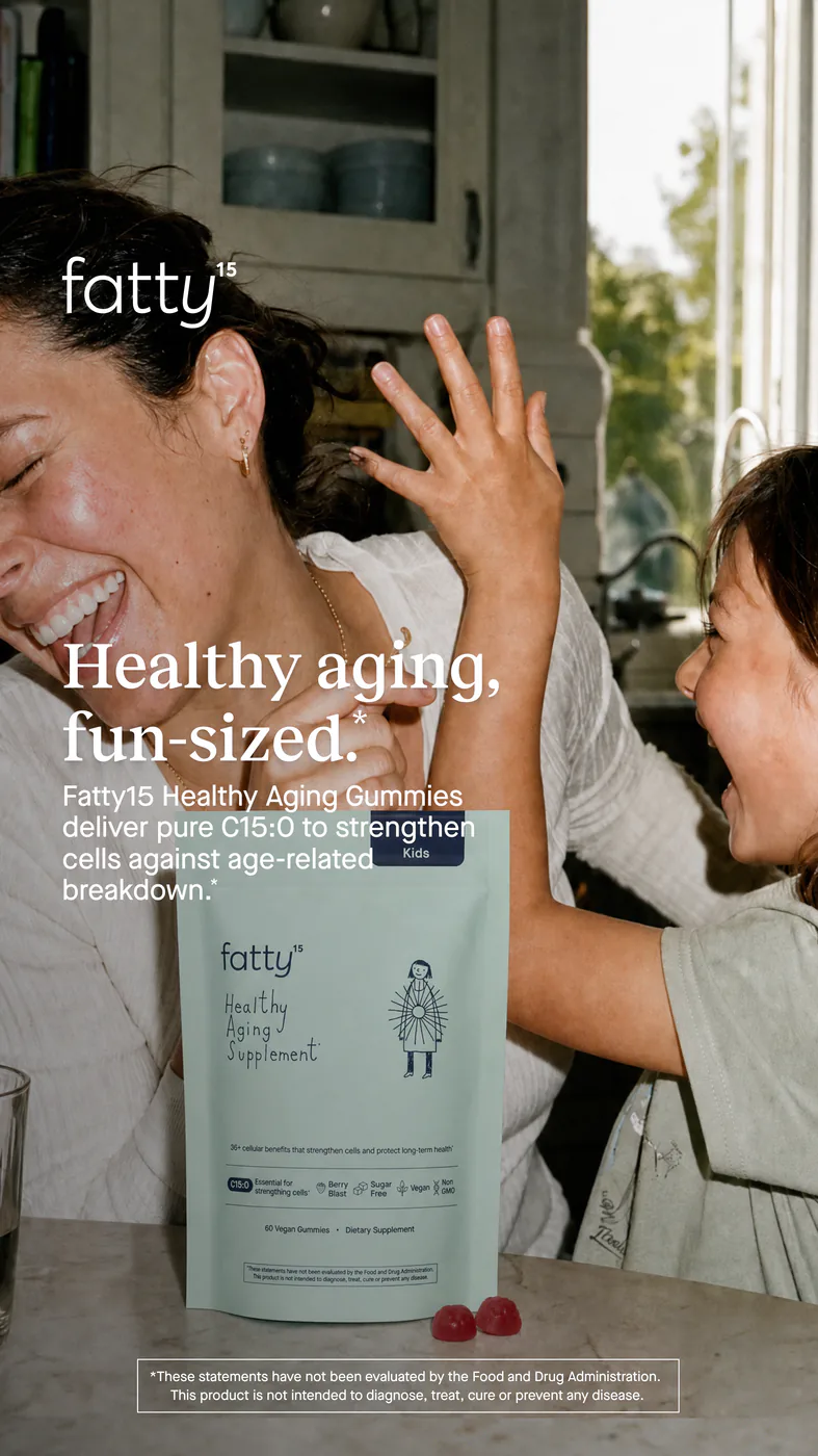 A laughing mother and child in a kitchen, with a pouch of fatty15 for kids.